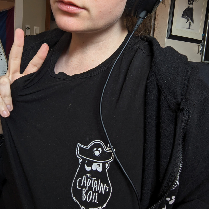 me throwing up a peace sign in a t-shirt with the logo for chain restaurant 'the captain's boil'